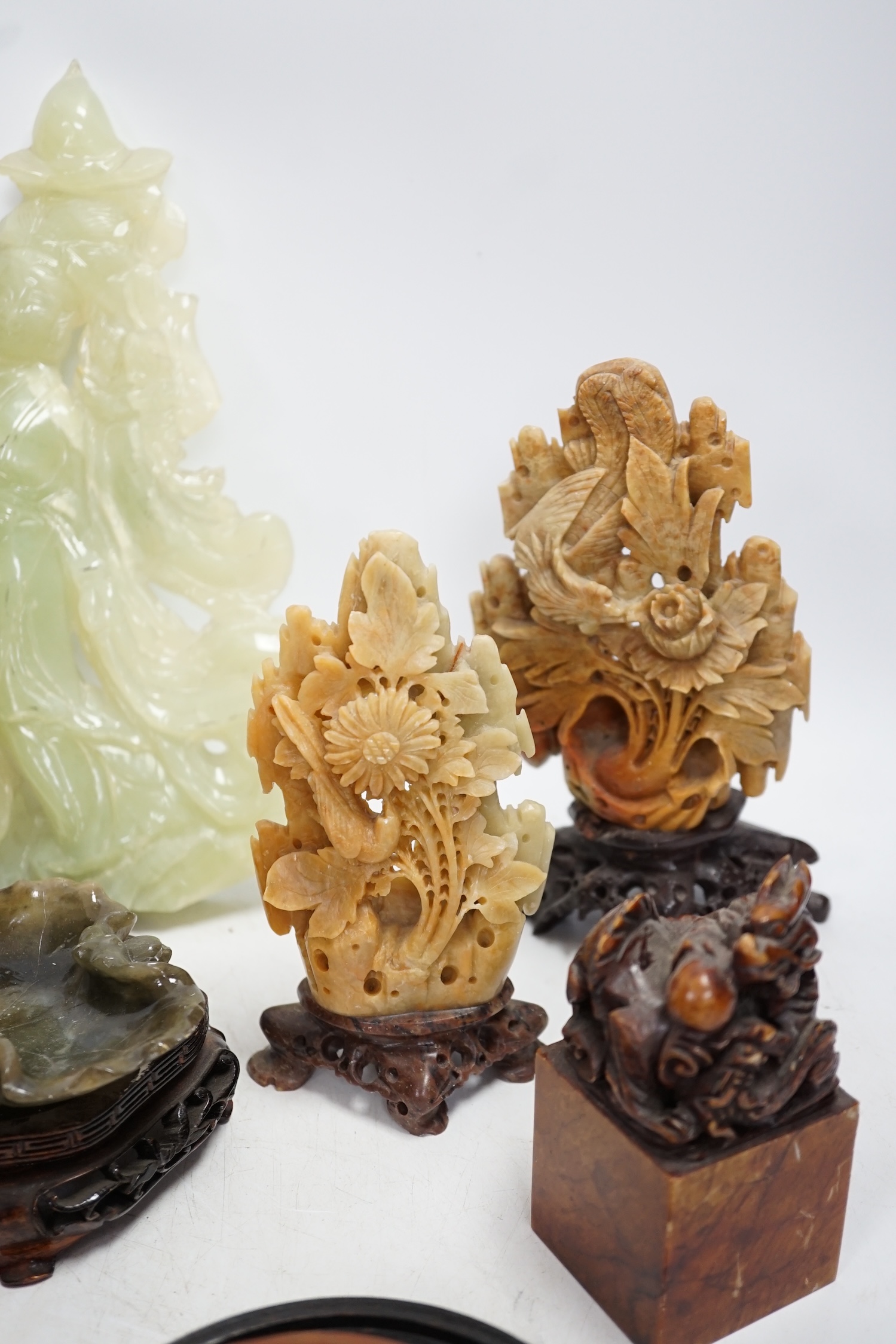 A group of nine Chinese hardstone and soapstone figures, tallest 26cm. Condition - fair